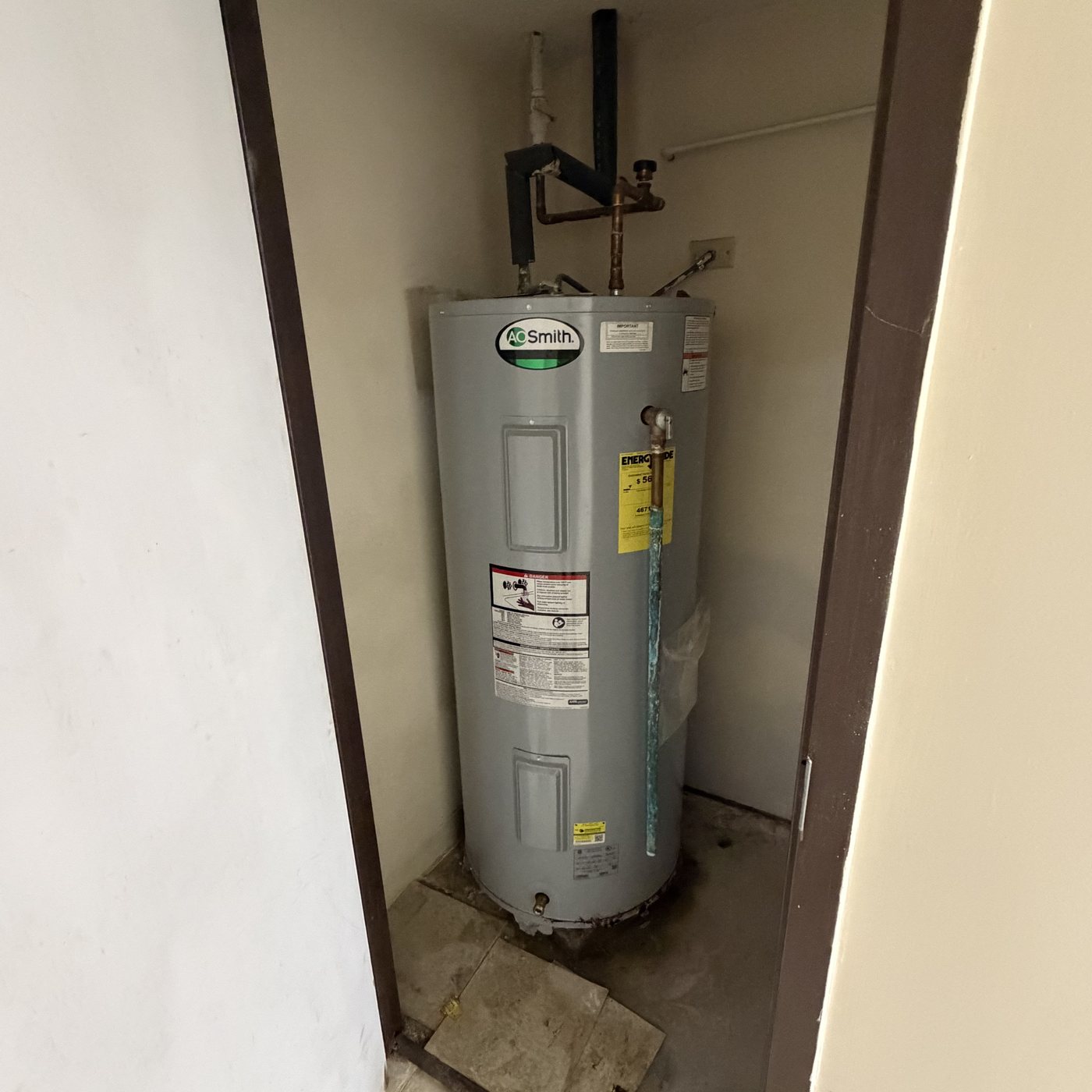 Leaking A.O. Smith electric water heater in a Haverhill utility closet
